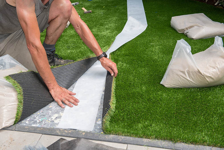 man installing the fake grass